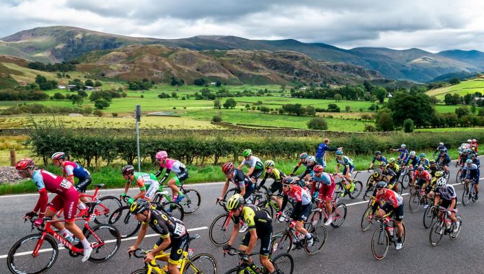 a group of cyclists taking part in an event in the background are the lake district fells