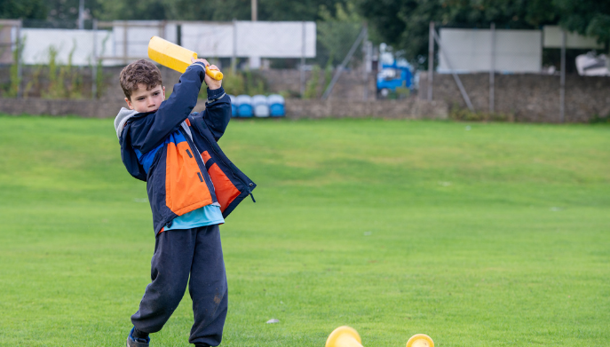 a boy playing cricket
