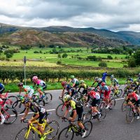 a group of cyclists taking part in an event in the background are the lake district fells
