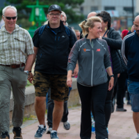 a group of adults walking outdoors