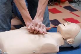 Performing first aid on a dummy