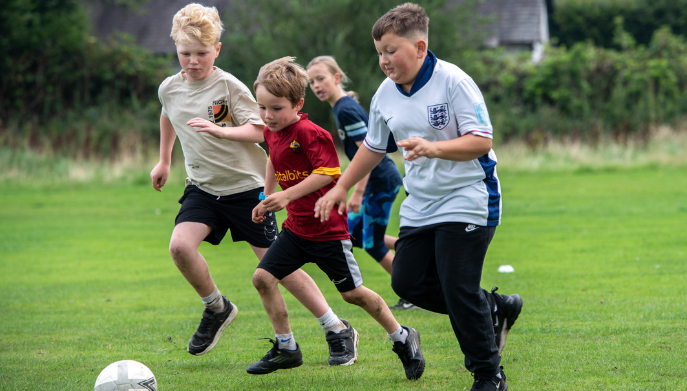 a group of young people playing football