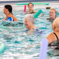 a group of older ladies taking part in an aquafit session