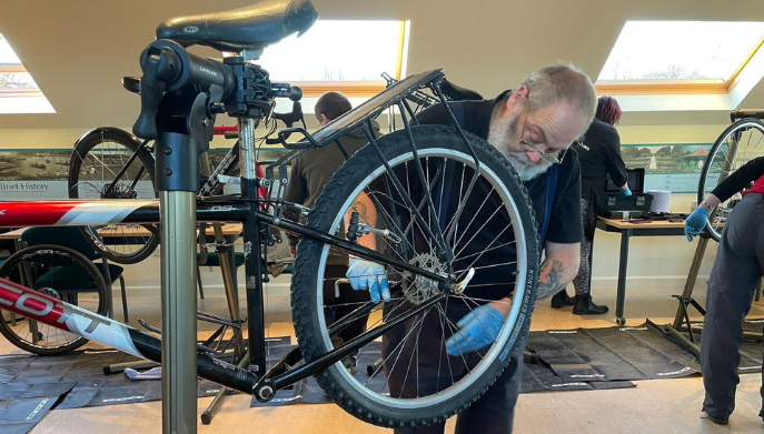 A man fixing a bike.