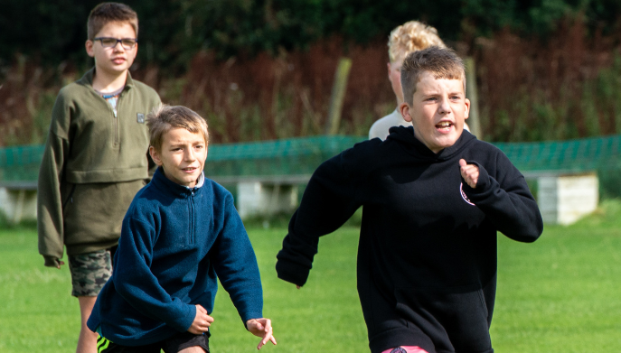 Young boys running outdoors