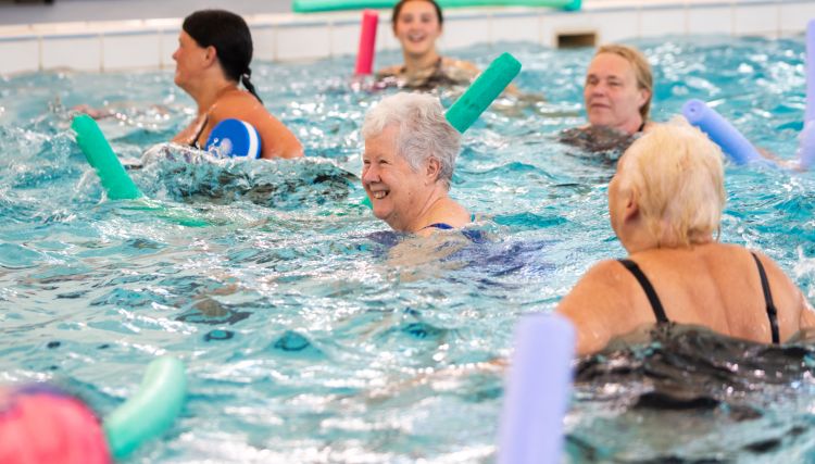 a group of older ladies taking part in an aquafit session