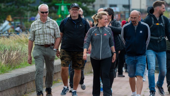 a group of adults walking outdoors